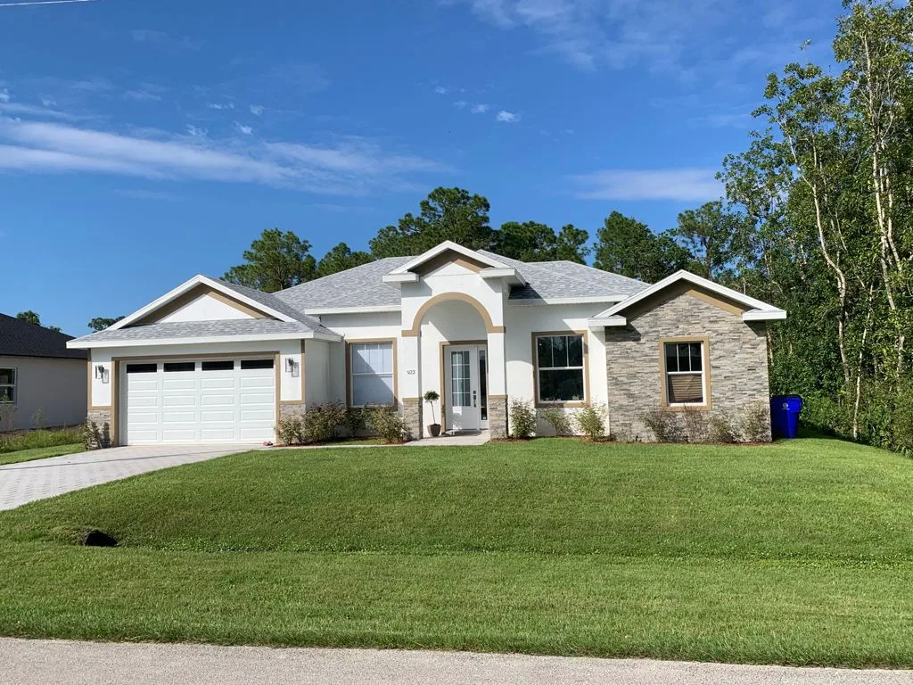Aurora custom home exterior with arched entry