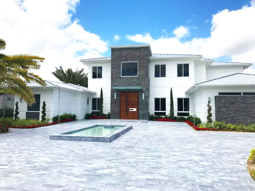 Casablanca custom home exterior with paver driveway